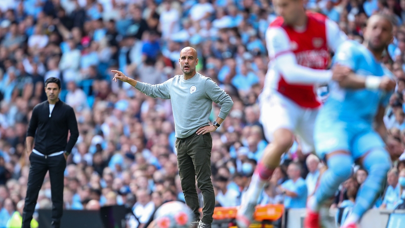 Pep Guardiola's (C) champions are chasing the team managed by his former assistant Mikel Arteta (L)