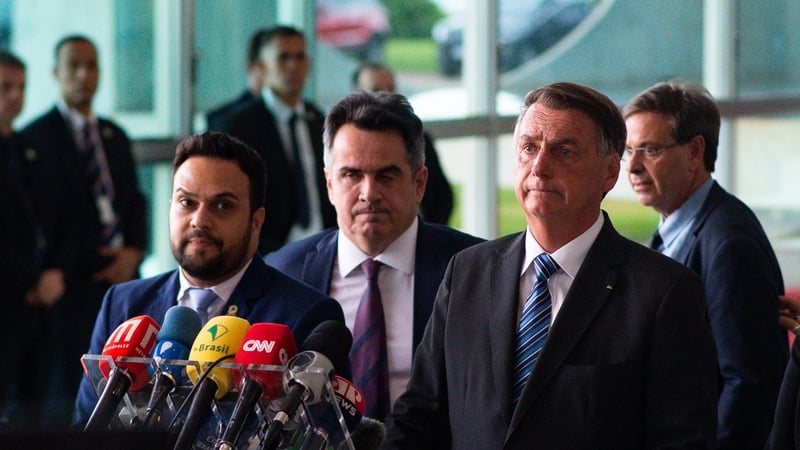 Outgoing Brazilian President Jair Bolsonaro (R) said he would not hand over the presidential sash to Luiz Inacio Lula da Silva (file)