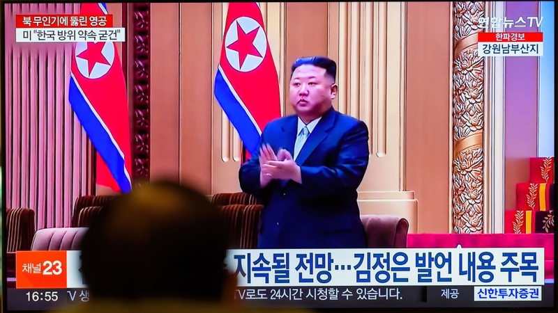 A TV screen in Seoul shows a news program reporting footage of North Korean leader Kim Jong Un