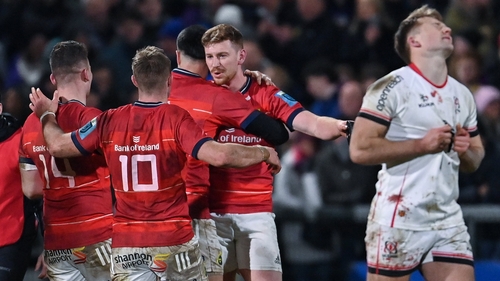 Munster players mob Ben Healy after his match-winning kick