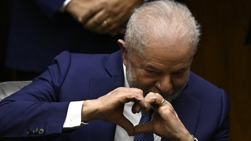 Luiz Inacio Lula da Silva makes a love heart sign during his inauguration