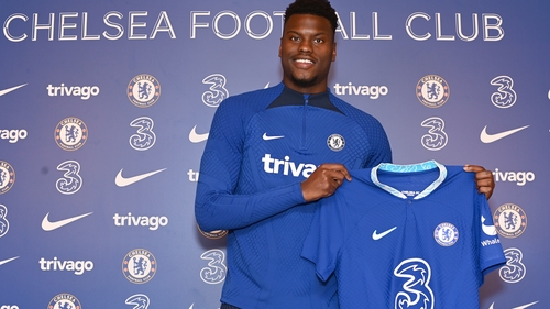 Benoit Badiashile poses with his Chelsea shirt