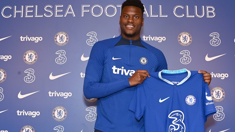 Benoit Badiashile poses with his Chelsea shirt