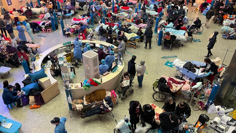 Patients, mostly with Covid symptoms, overwhelm the hall of a building at Changhai Hospital in Shanghai