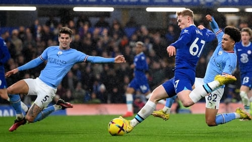 Lewis Hall has a shot whilst under pressure from John Stones