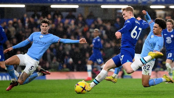 Lewis Hall has a shot whilst under pressure from John Stones