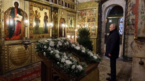 Vladimir Putin attends an Orthodox Christmas mass in the Cathedral of the Annunciation at the Kremlin in Moscow, late on 6 January