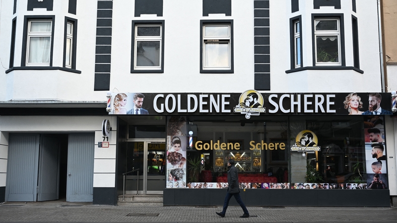 A man walks past a house in Castrop-Rauxel where police arrested an Iranian man on suspicion of having prepared a serious act of violence threatening the security of the state