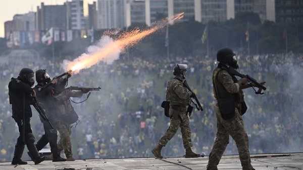 Shots are fired at security forces attempt to disperse rioters around the Brazilian congressional building
