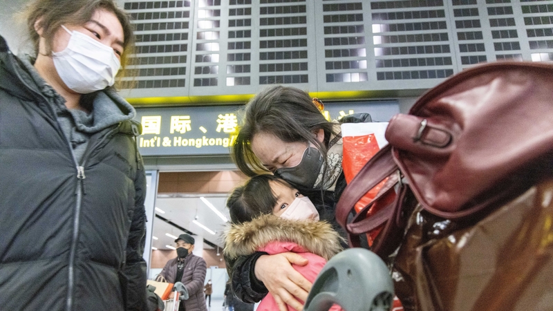 Family members embrace at Shenyang Taoxian International Airport as China lifts Covid-19 restrictions