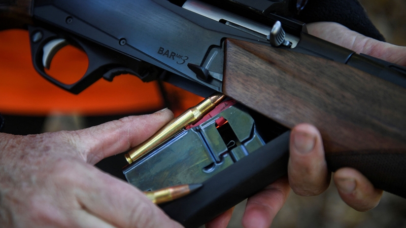 A man loads a gun amid a hunting party in Moulis, southwestern France