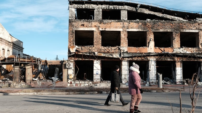 Pedestrians in the heavily damaged town of Izyum