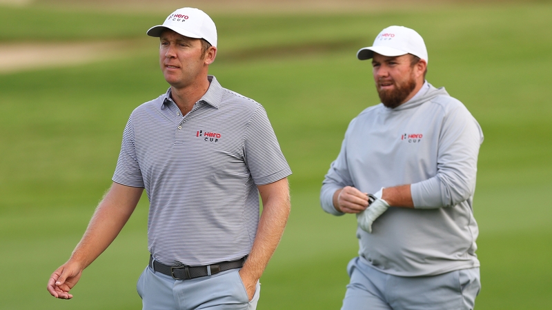 Seamus Power walks with Shane Lowry of Ireland on the first hole during the Morning Foursomes