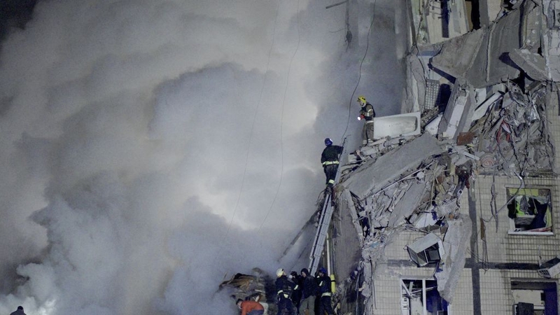 Rescuers works on a residential building destroyed after a missile strike in Dnipro