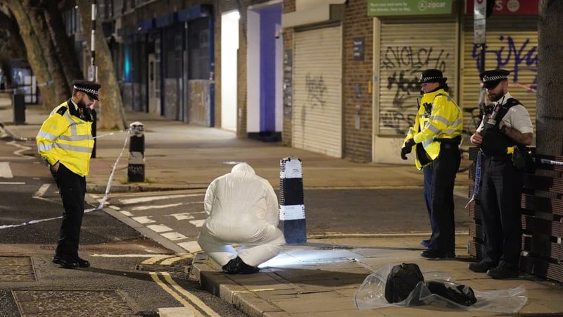 Forensics officers examine the scene after the shooting