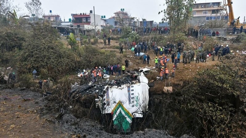 Rescuers inspect the wreckage at the site of a Yeti Airlines plane crash in Pokhara