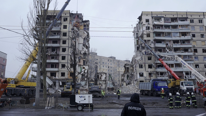 Rescuers search the ruins of the apartment complex hit by a Russian strike in Dnipro, Ukraine
