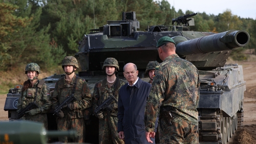 German Chancellor Olaf Scholz pictured in front of a Leopard 2 main battle tank of the German armed forces during a training exercise in October