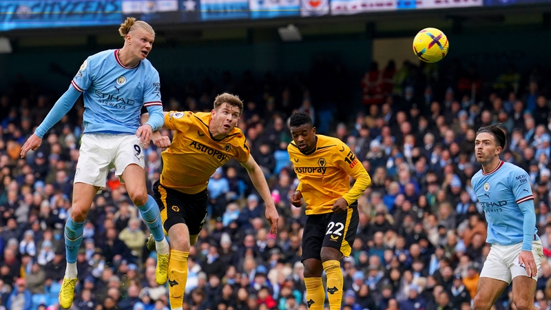 Nathan Collins of Wolves can only watch as Erling Haaland rises to score his first