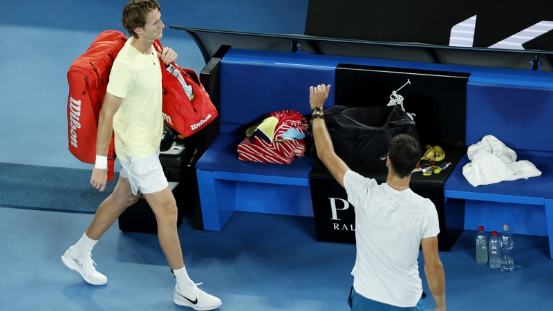 Sebastian Korda walks off the court after retiring during the third set