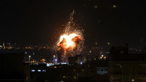 Fire and smoke rise above buildings after an Israeli air strike on Gaza