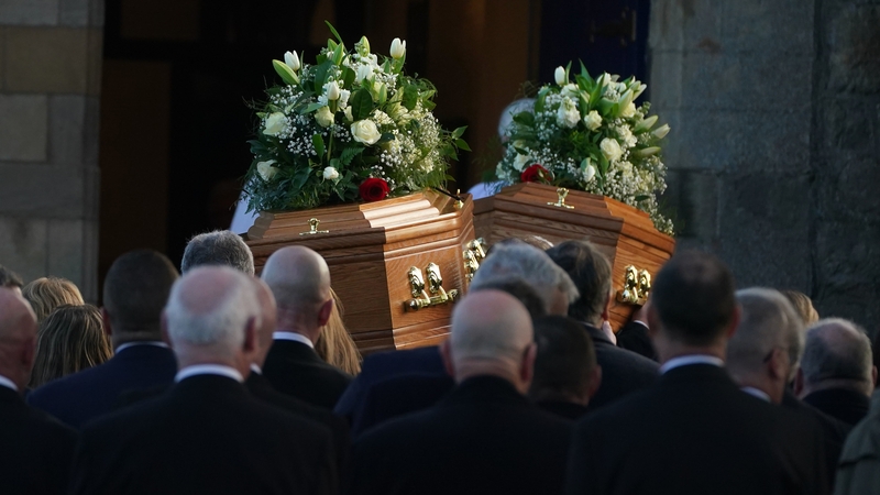 The coffins carrying the remains of Alex and Ann Easton are carried into Bangor Abbey