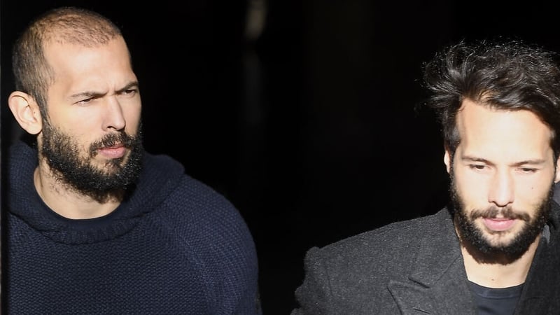 Andrew Tate (L) and his brother Tristan leaving court in Bucharest today