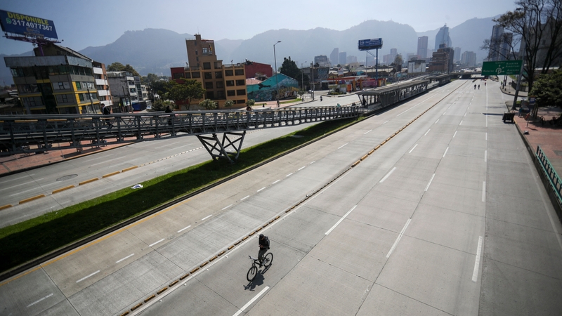 A cyclist travels on an empty motorway in Bogota during their carless day. Pic: Getty