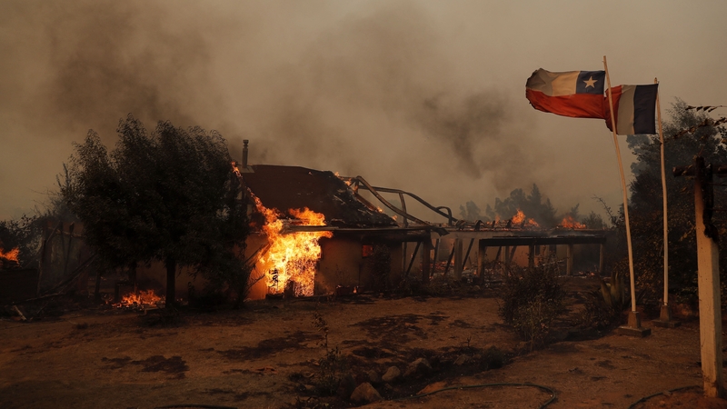Flames engulf a house during a fire in Santa Juana, Concepcion province, Chile