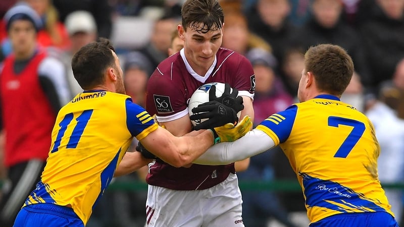 Mathew Tierney is tackled by Roscommon pair Diarmuid Murtagh and Niall Daly