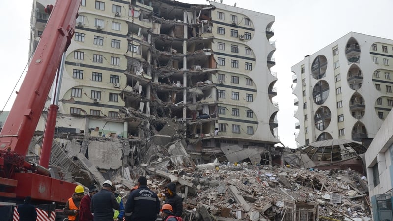 Rescue workers search the rubble of a collapsed building in Diyarbakir, Turkey