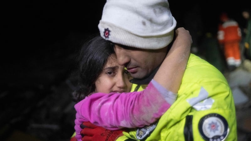 Police officer Zekeriya Yildiz hugs his daughter after they saved her from the rubble in Hatay, Turkey
