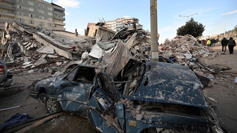 A collapsed building and a destroyed car in southeastern Turkish city of Kahramanmaras following the 7.8 magnitude quake
