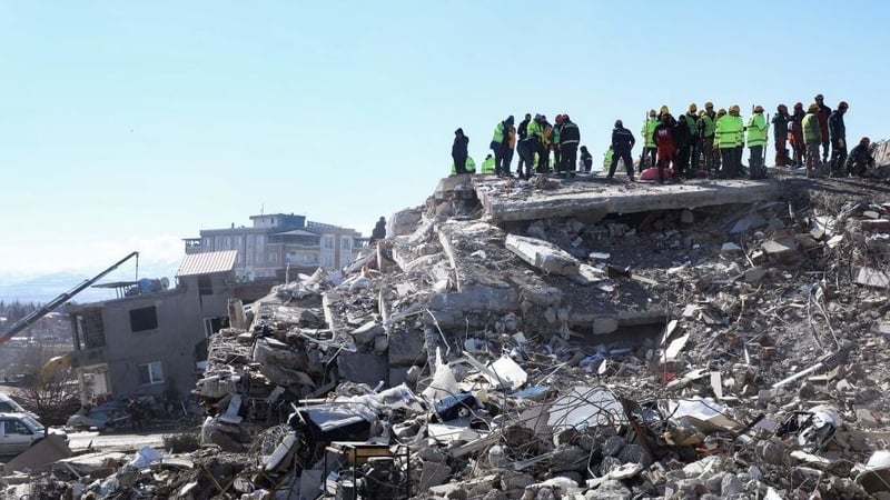Rescuers and civilians look for survivors under the rubble of collapsed buildings in Nurdagi, in the countryside of Gaziantep