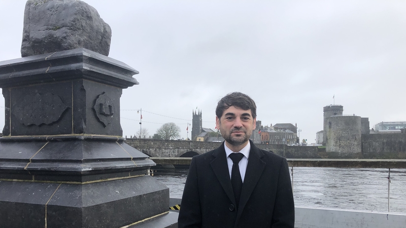 Dr Loïc Guyon, Honorary Consul of France in Limerick, next to Limerick's Treaty Stone and opposite King John's Castle