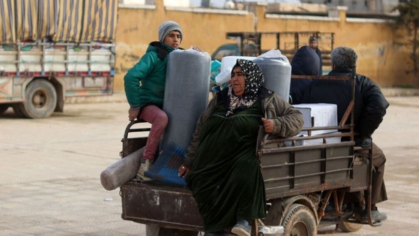 Syrians who were made homeless after the quake receive humanitarian aid as they settle in a makeshift camp set up in a school in the town of Atareb