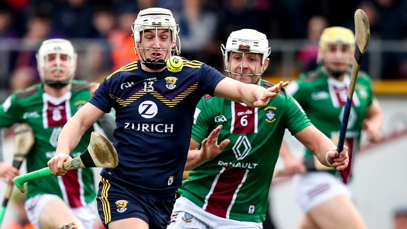 Wexford's Cathal Dunbar (L) races away from Shane McGovern of Westmeath