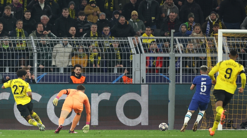 Karim Adeyemi (L) slots home the decisive goal