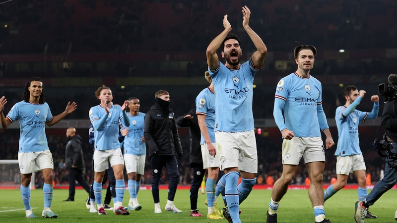 Manchester City players salute the away end after their win at Arsenal