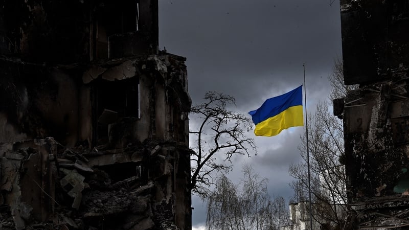 The Ukrainian flag flutters between buildings destroyed in bombardment in the Ukrainian town of Borodianka in the Kyiv region