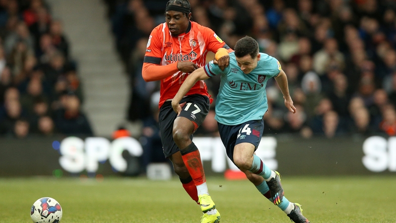 Burnley's Josh Cullen attempts to escape the grasp of Luton Town's Pelly-Ruddock Mpanzu