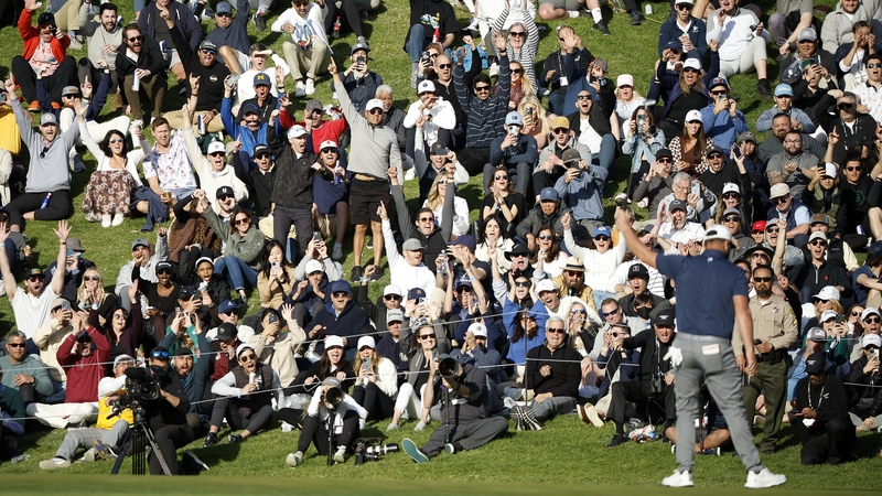 Rahm celebrates his birdie putt on the last