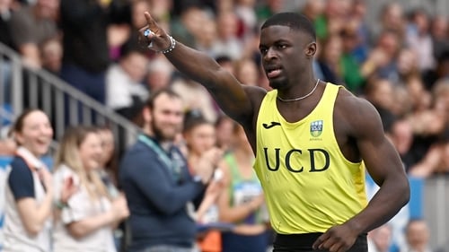 Israel Olatunde celebrates after landing the indoor 60m title with a national record time