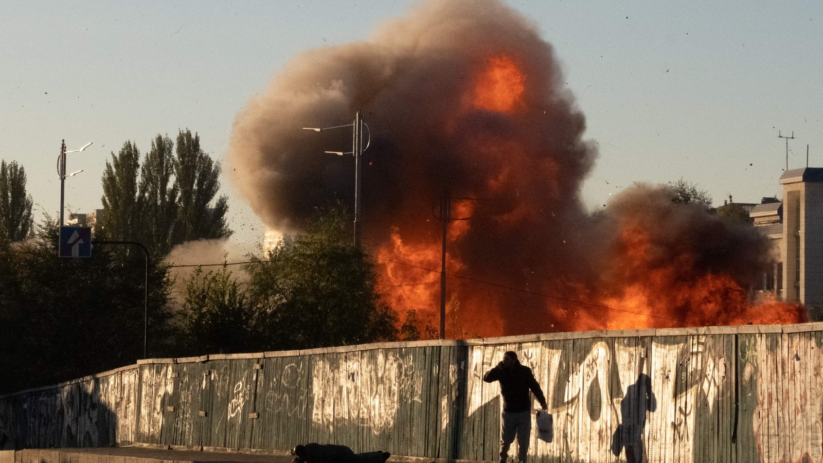A man falls to the ground during a drone strike on Kyiv on 17 October 2022.