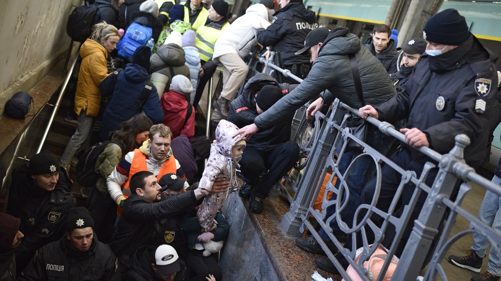 An evacuation train to Poland from Lviv: On 28 February 2022, a baby is passed up during frantic scenes as people board to leave.