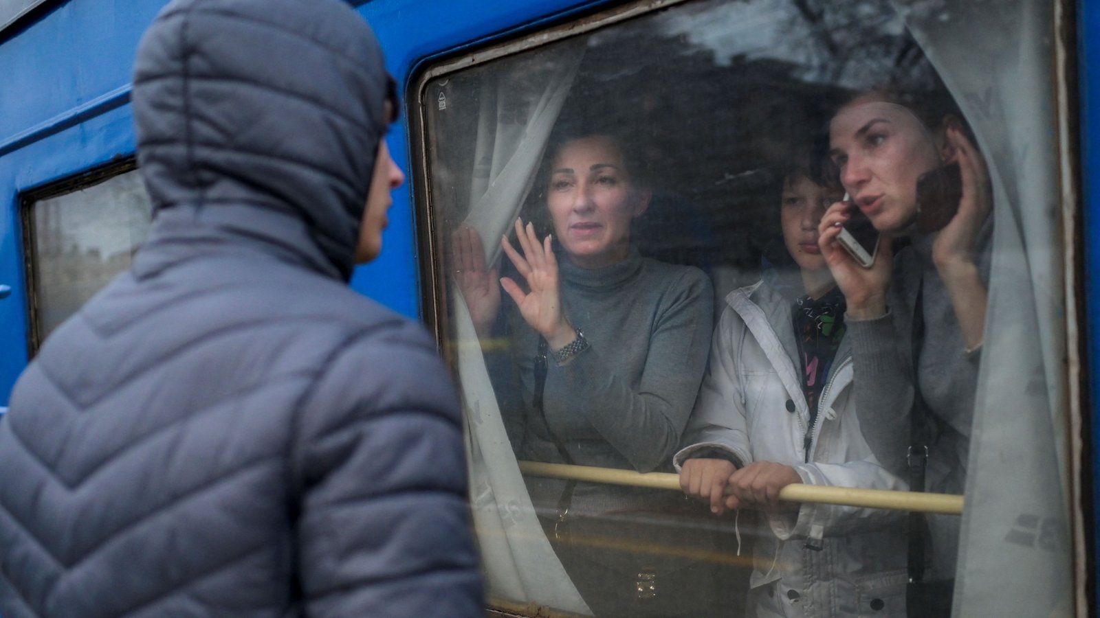 A family say goodbye to a young man at the central train station in Odesa on 6 March 2022.