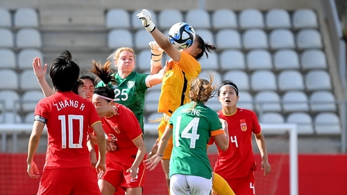 China goalkeeper Xu Huan rises with Aoife Mannion