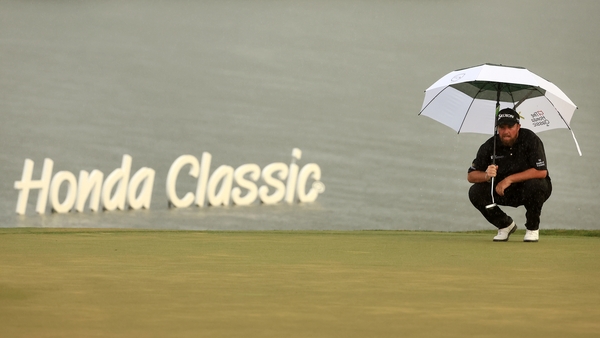 Shane Lowry takes shelter during last year's Honda Classic