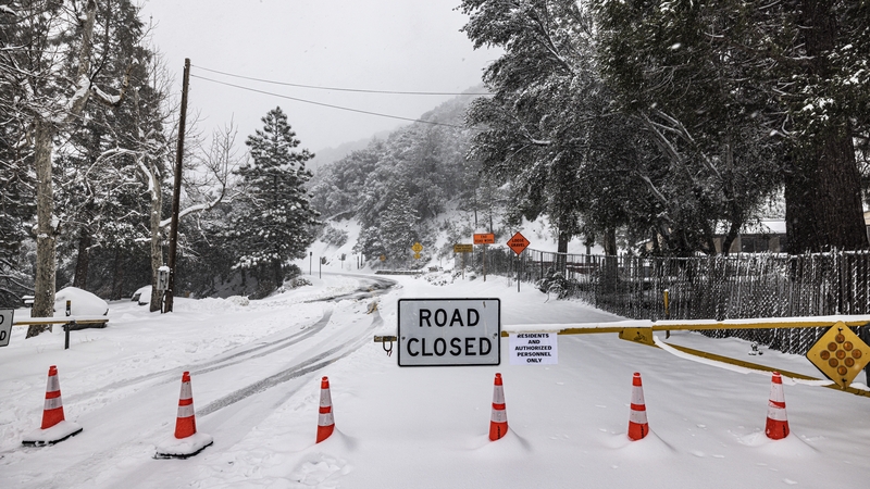 Snow falls on Highway 2 in the local mountains above Los Angeles