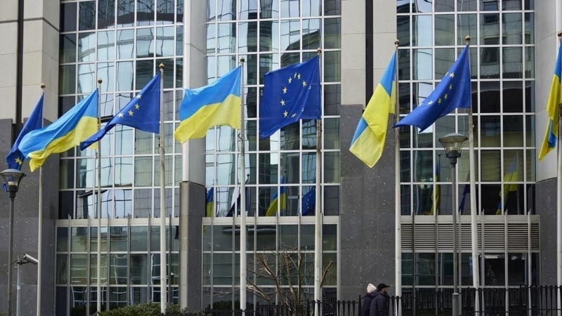 EU and Ukraine flags outside the European Parliament building in Brussels to mark the anniversary of the war
